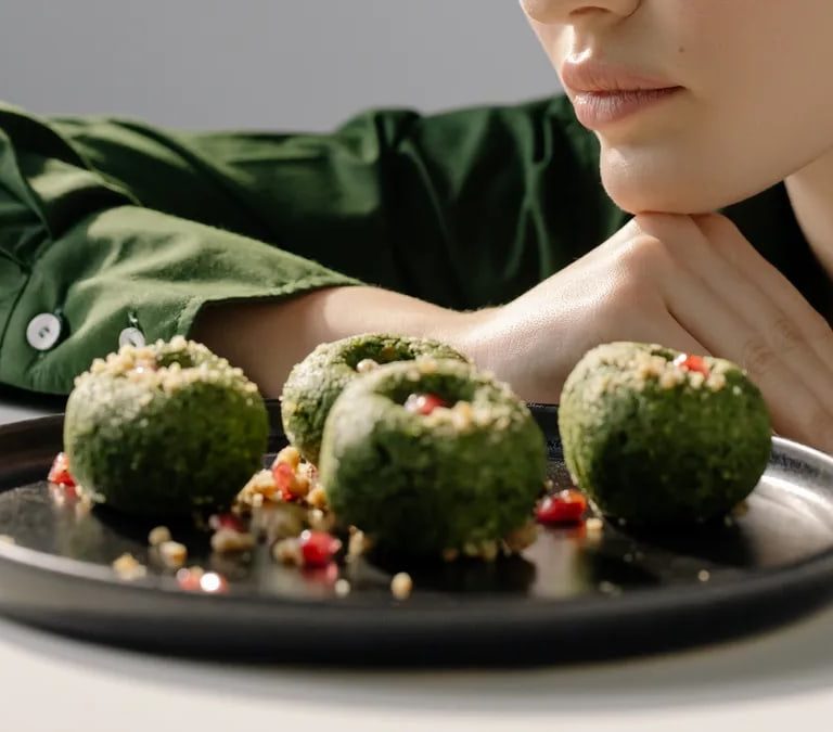 Close-up of spinach pkhali, a Georgian vegan dish, with a woman in green observing.